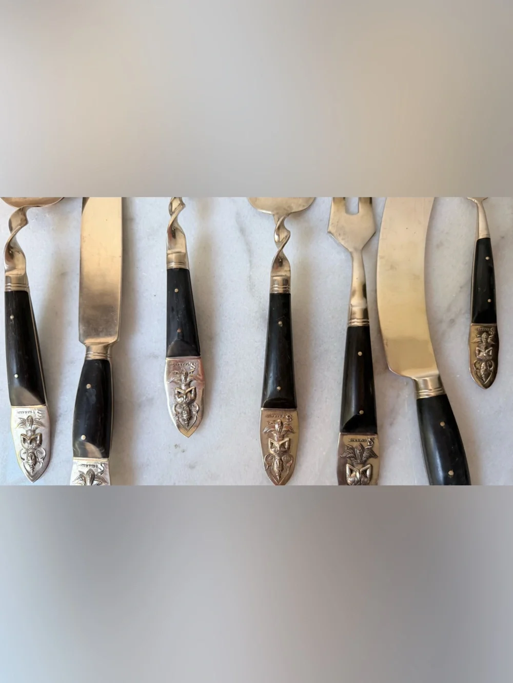 set consists of vintage Thai brass or bronze utensils with dark wooden handles.